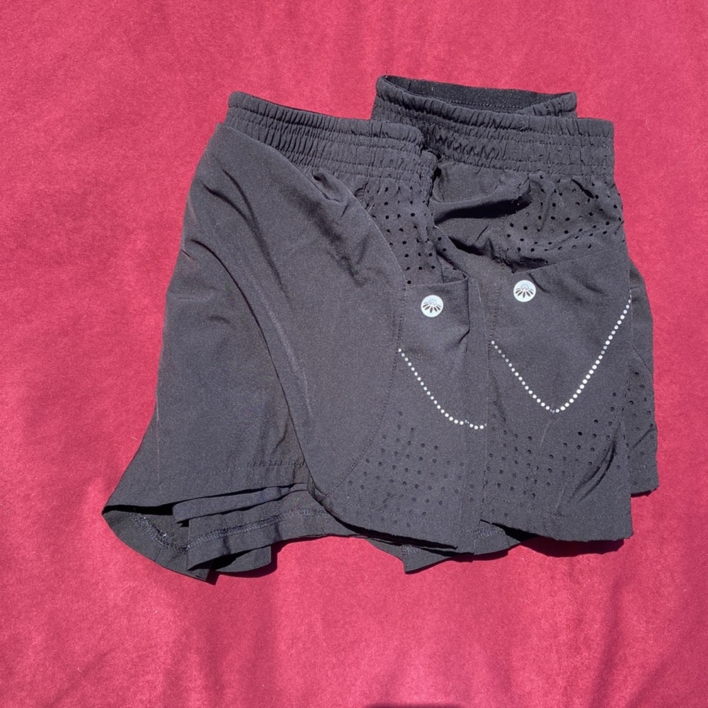 Two pair of identical running shorts with phone pockets